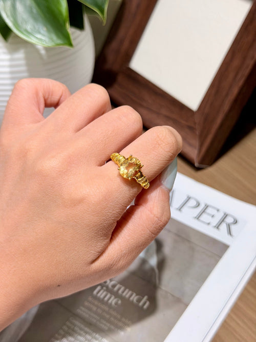 Golden citrine adjustable ring worn on a finger