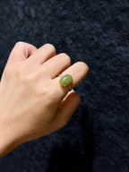 Hetian jade solitaire ring with 18K gold plated setting worn on a finger