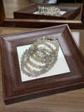 Silver Moonlight Bracelet Set coiled in a wooden tray, silver moonstone beads