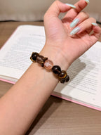 Deep-toned multi-gemstone bracelet worn on a wrist