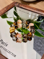 Golden tiger's eye bracelet with red hematoid quartz on a mirror