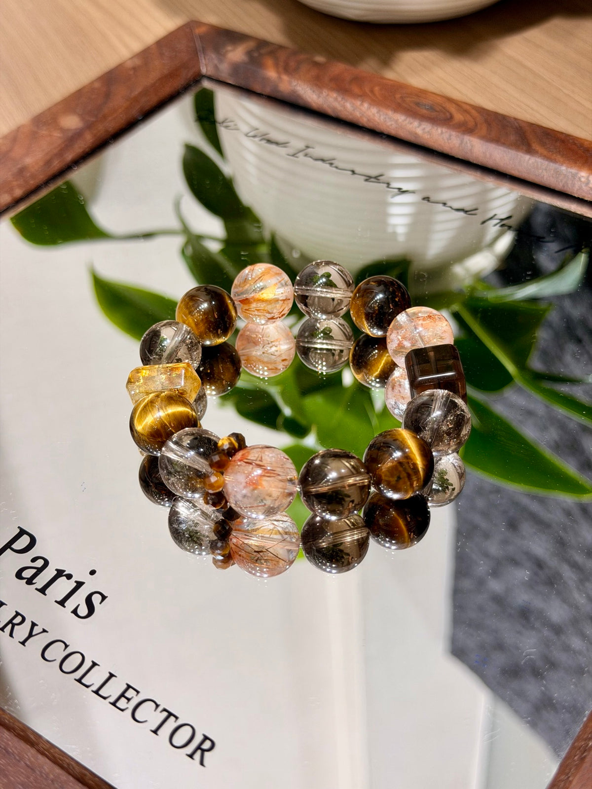 Golden tiger's eye bracelet with red hematoid quartz on a mirror