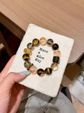 Multi-gemstone bracelet with golden tiger's eye and smoky quartz on a card