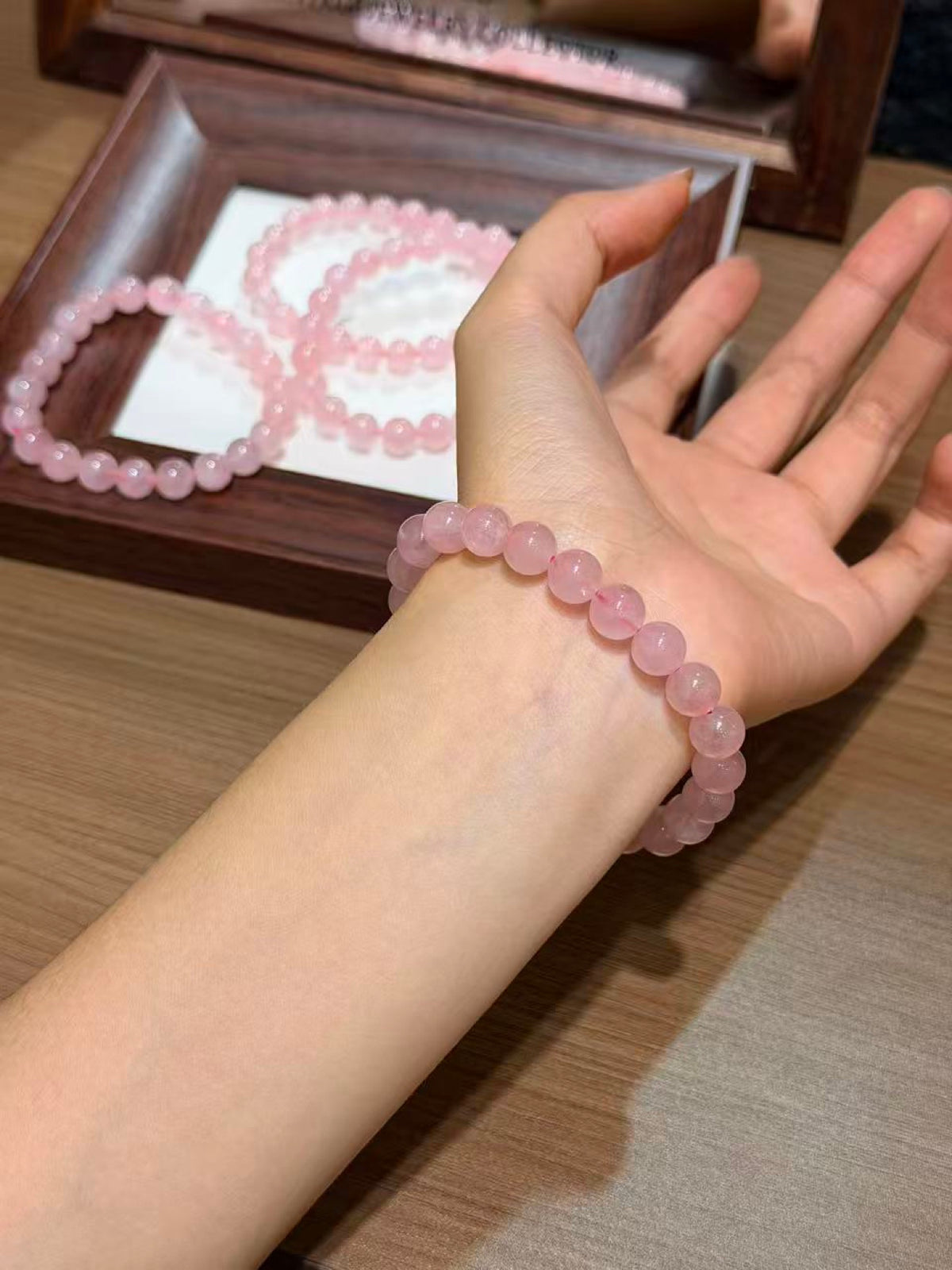 Blush Grapefruit Bracelet worn on wrist, translucent pink quartz beads