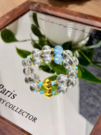 Blue and clear crystal bracelet with gold heart on a mirror
