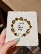Tiger's eye and smoky quartz bracelet with clear quartz cube on a card