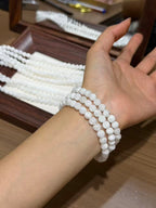 Snowfall Triple-Loop Bracelet worn on wrist, triple wrap of translucent white beads