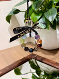 Colorful multi-gemstone crystal car charm with black ribbon bow