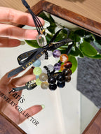 Crystal car charm with colorful gemstone beads over a mirror