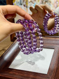 Regal Amethyst Bracelet worn on wrist, translucent purple amethyst beads