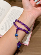 Amethyst and kyanite double-loop bracelet worn on wrist with beaded tassel