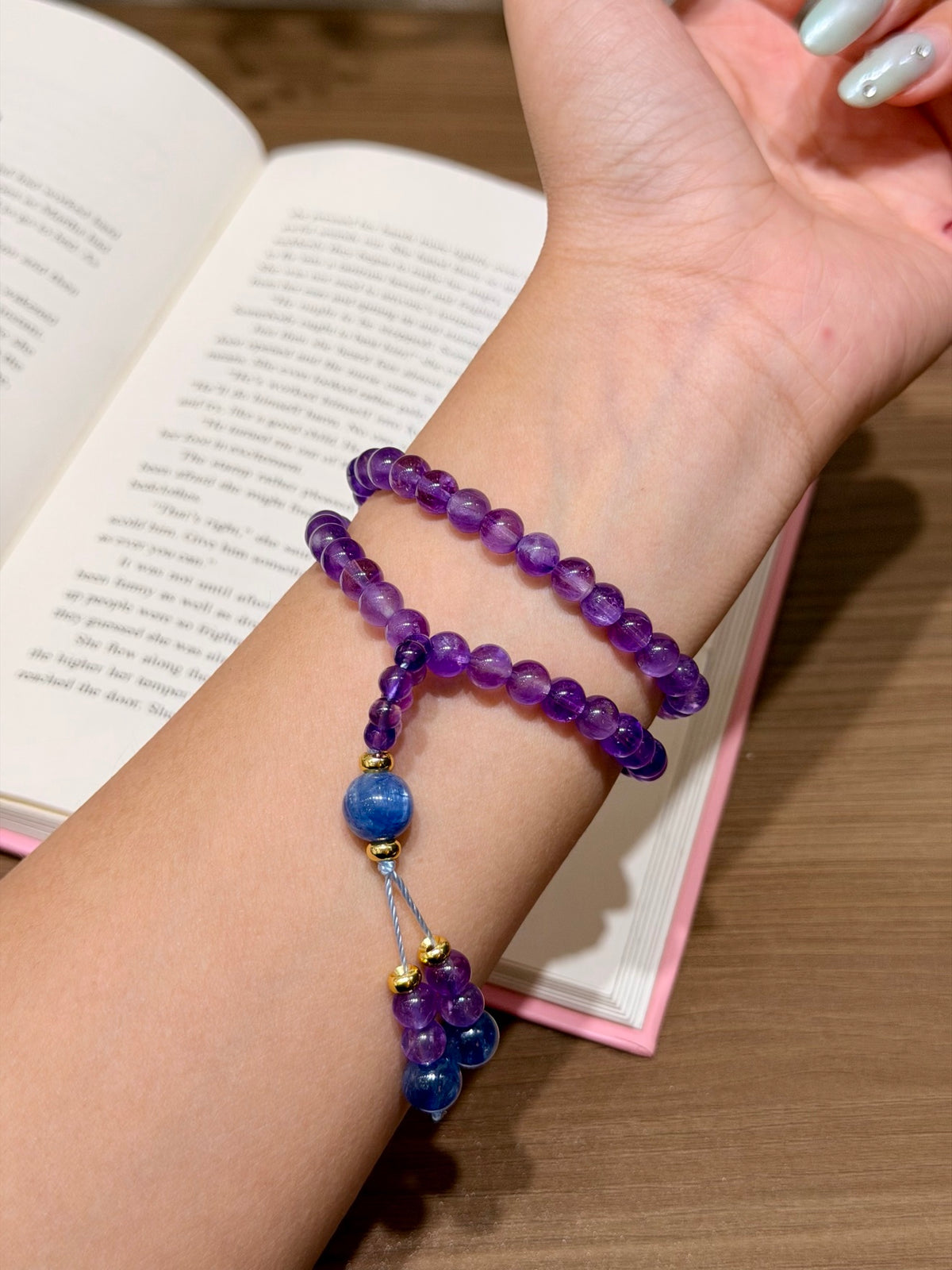 Amethyst and kyanite double-loop bracelet worn on wrist with beaded tassel